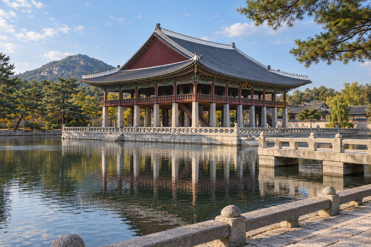 A long two-storey timber pavilion on a square stone island across a wide pond. Editorial image.