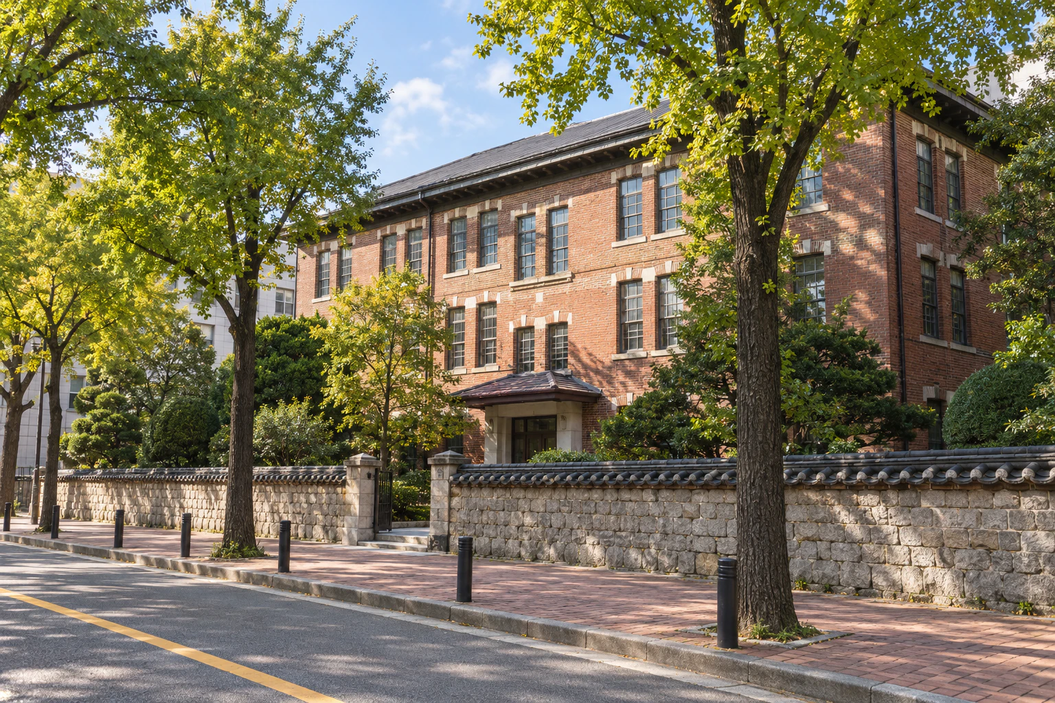 A red-brick three-storey school building with white window frames rising behind a low stone wall capped with tiles — editorial reconstruction.