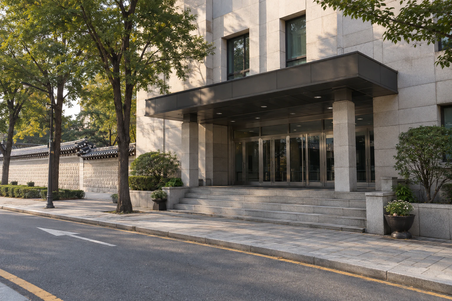 The front entrance and glass doors of a government building seen from Deoksugung-gil. Editorial image.