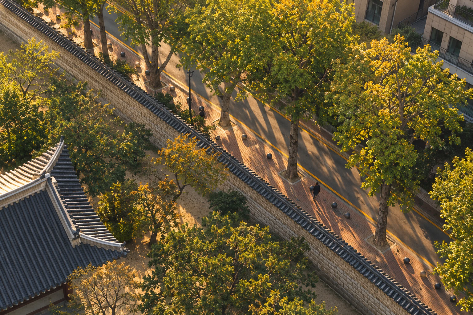 The long shadow of a wall on a pavement in afternoon sun, seen from above. Editorial image.