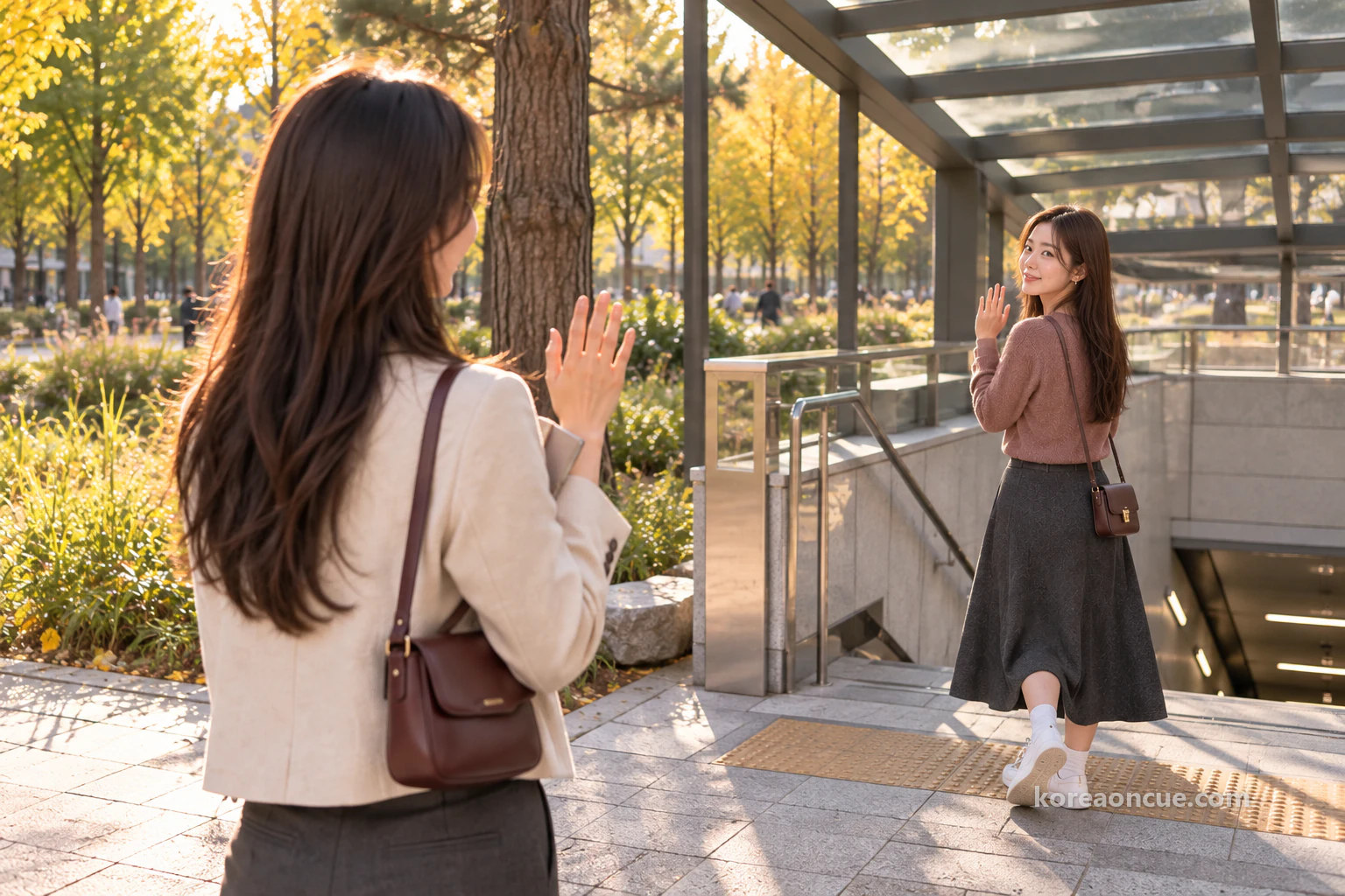 Mali waving goodbye by the pine tree at the exit at dusk, and Rina waving back with her notebook held to her chest. Editorial image.